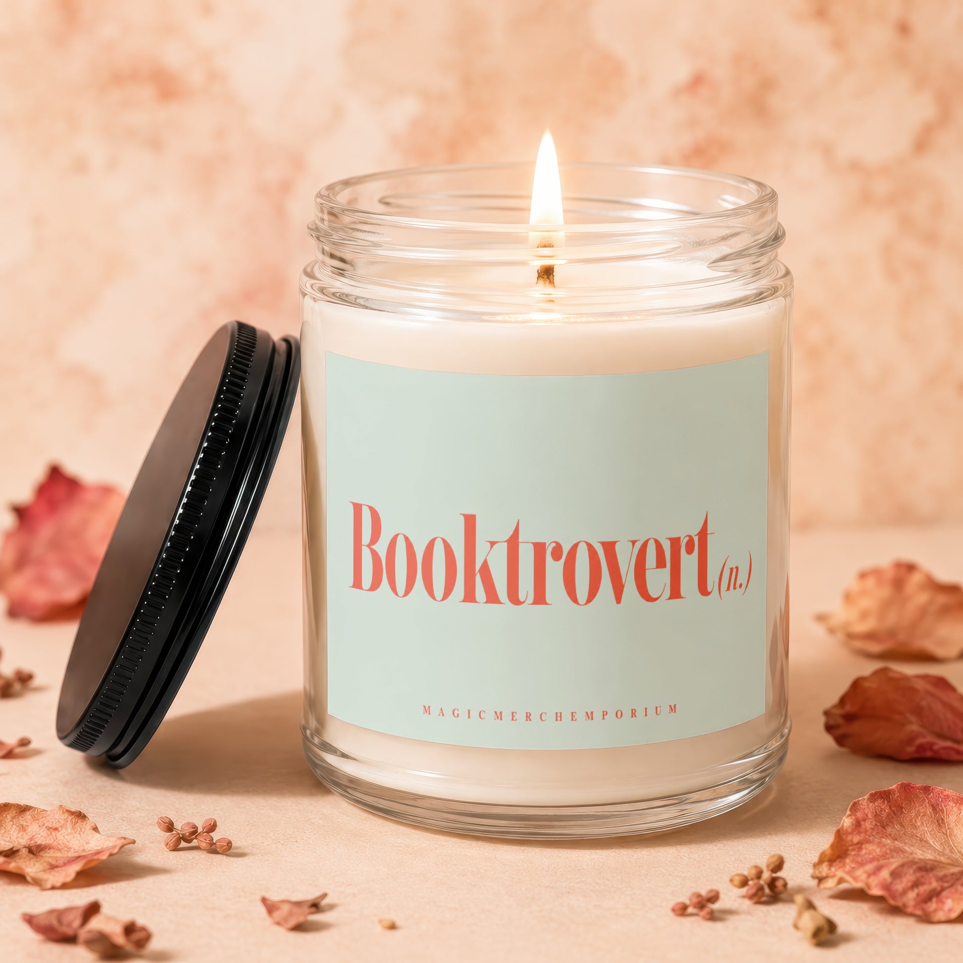 Candle burns with flame, labeled Booktrovert (n.) and Magic Merch Emporium.
