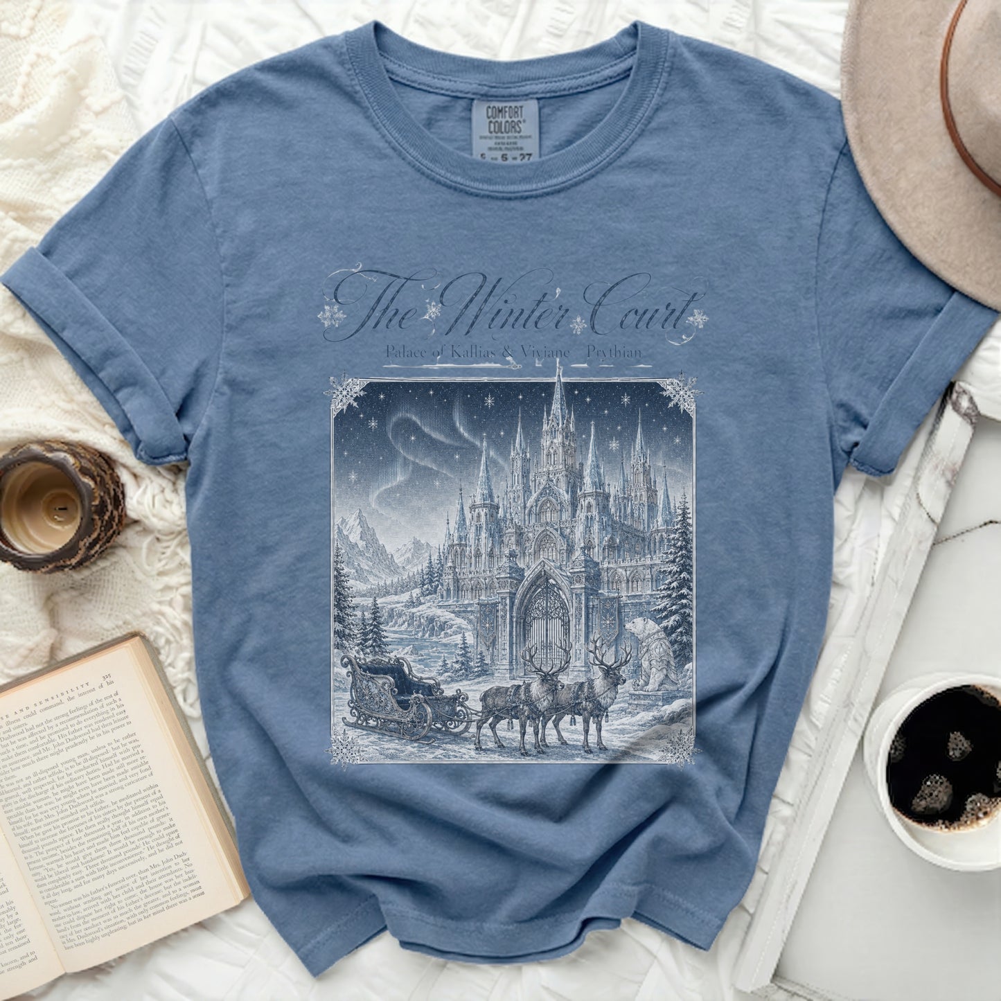 Blue t-shirt with "The Winter Court" design featuring a winter palace, sleigh, and reindeer.