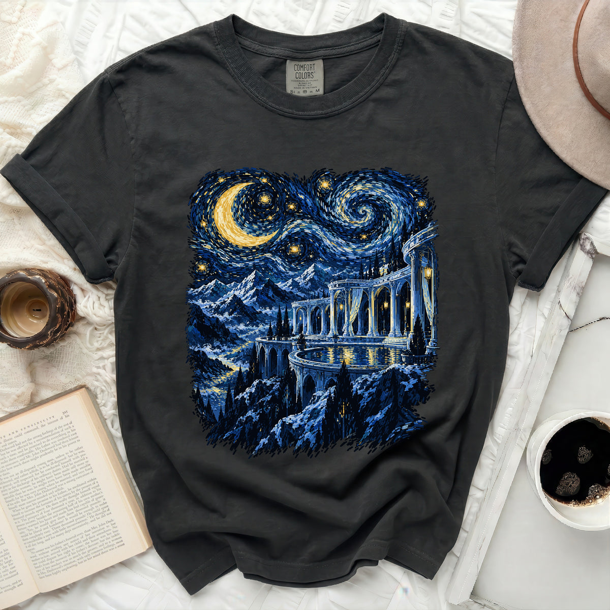 Dark t-shirt with a starry night landscape and castle design.