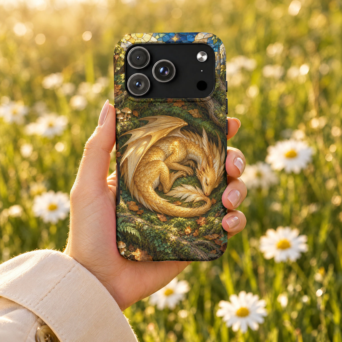 A hand holds a smartphone featuring a fantasy case with a sleeping golden dragon.