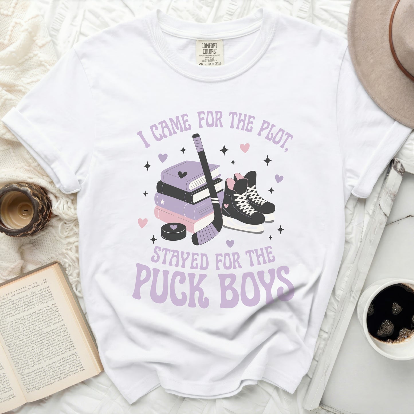 White t-shirt with purple text "I came for the plot. Stayed for the puck boys."