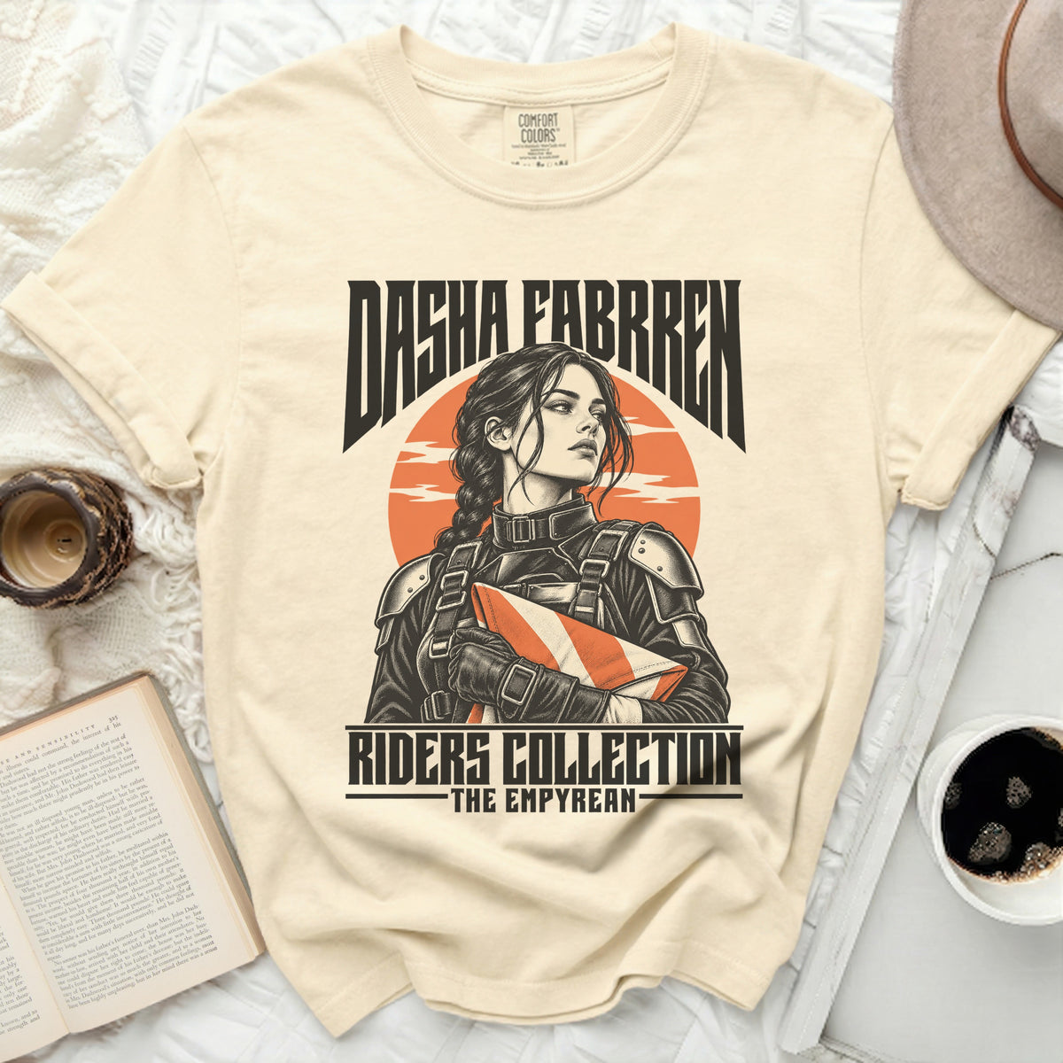 Cream t-shirt featuring "Dasha Fabrre" and "Riders Collection - The Empyrean" with a graphic.