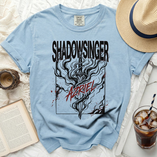 Light blue t-shirt with black "SHADOWSINGER" and sword graphic.