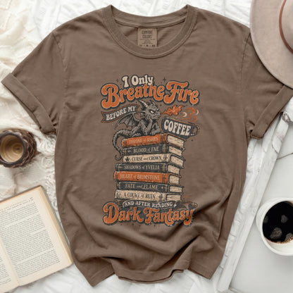 T-shirt with "I Only Breathe Fire Before My Coffee" and fantasy book titles.