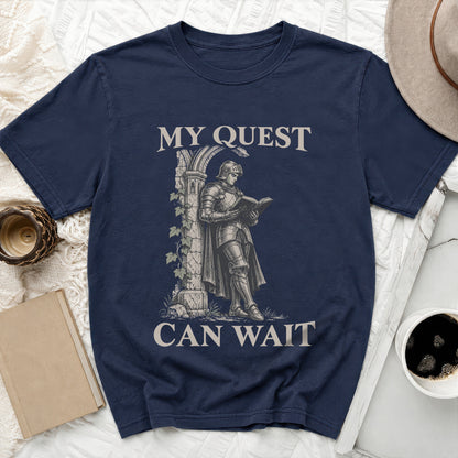 Navy t-shirt with knight reading a book and text "MY QUEST CAN WAIT".