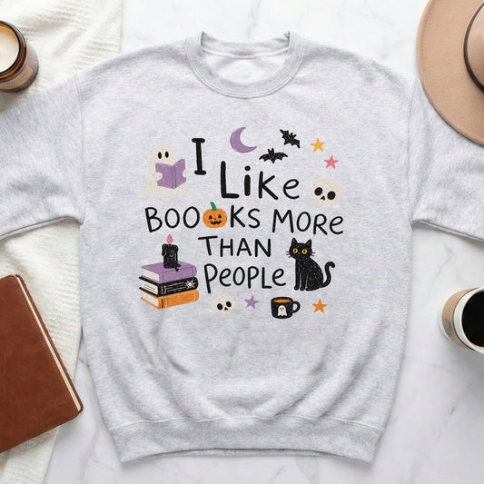 Gray sweatshirt with "I Like Books More Than People" Halloween graphic.