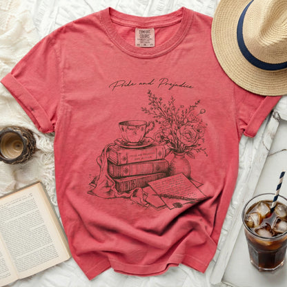 Pink t-shirt with "Pride and Prejudice" and stack of books illustration.