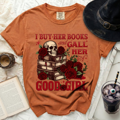 Orange t-shirt with skull, books, roses, and text "I BUY HER BOOKS and GALL HER A GOOD GIRL".