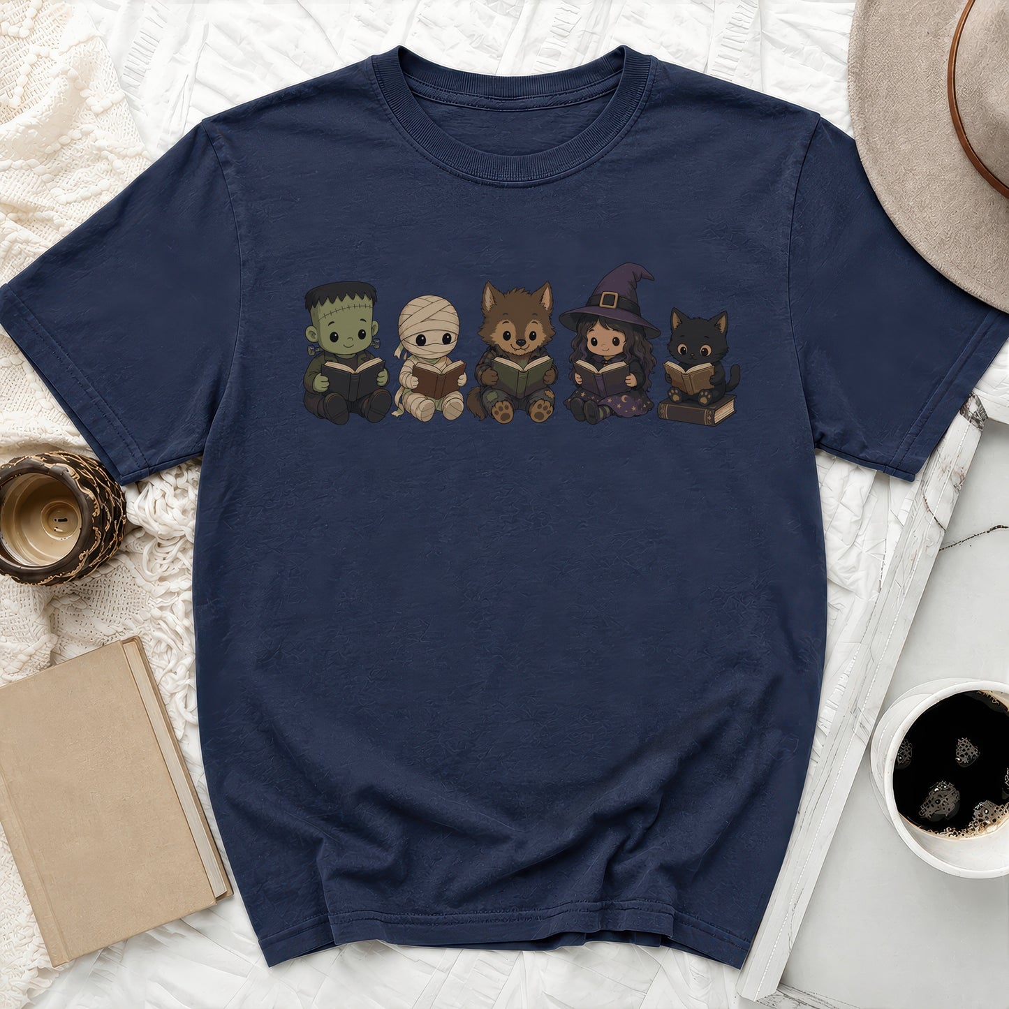 Frankenstein, mummy, wolf, witch, and cat characters reading books on navy t-shirt.