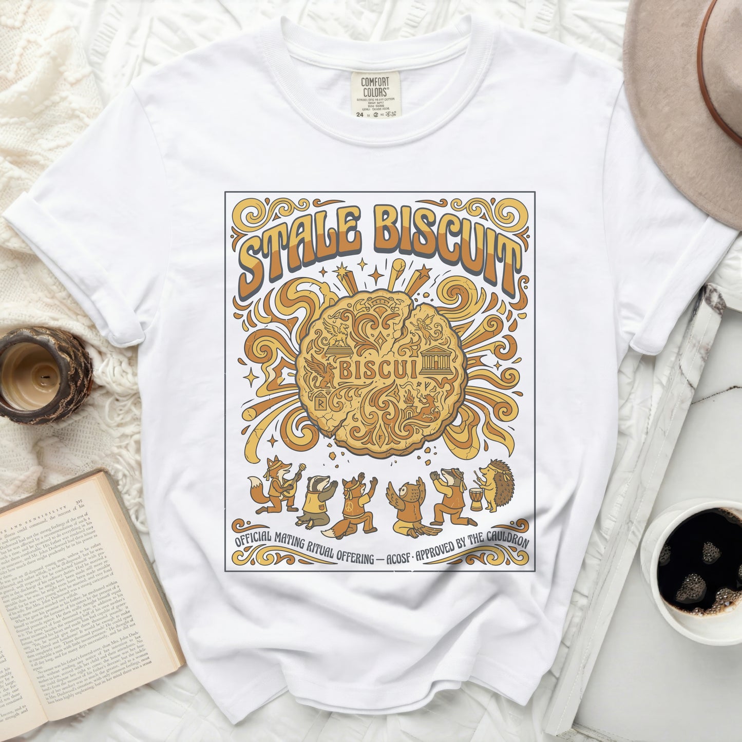 White t-shirt with "STALE BISCUIT" and woodland creatures performing a ritual.