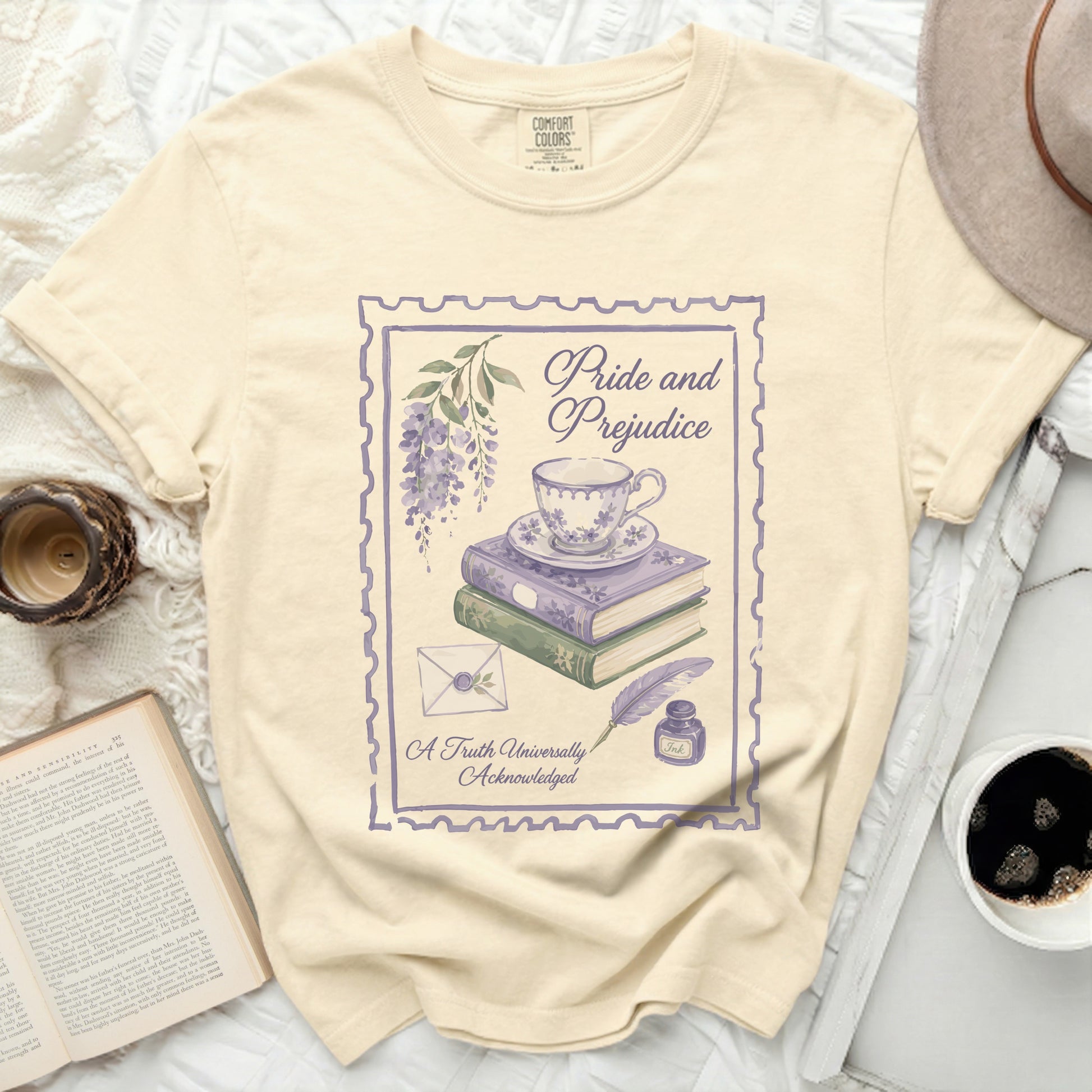 T-shirt with "Pride and Prejudice" literary design featuring teacup, books, and quill.