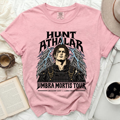 Pink t-shirt featuring Hunt Athalar with wings and lightning, and "Umbra Mortis Tour" text.