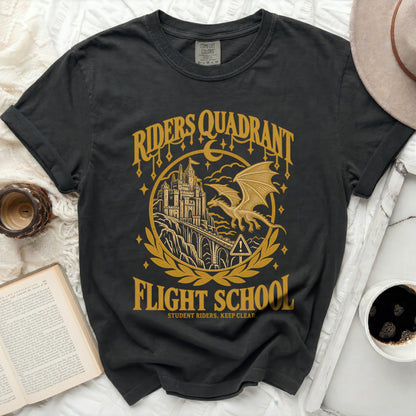 Dark grey t-shirt with gold graphic of a castle, dragon, and text "Riders Quadrant Flight School".