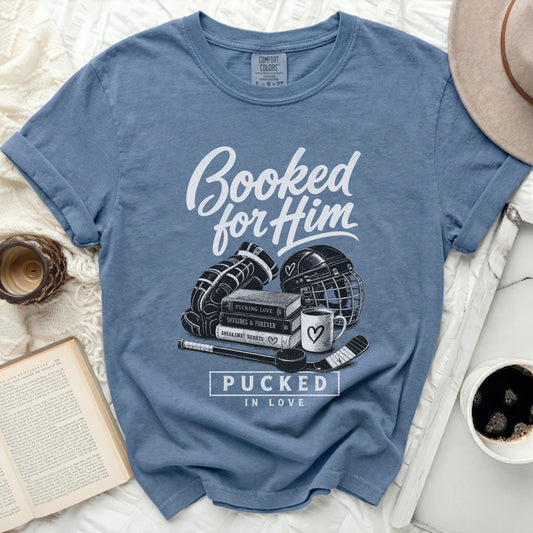 Blue t-shirt with "Booked for Him" and hockey puck graphics.