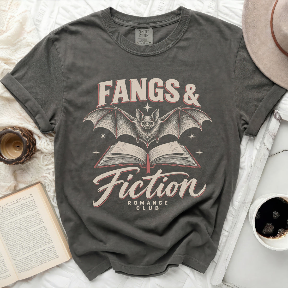 Dark gray t-shirt with "Fangs & Fiction Romance Club" and bat graphic.