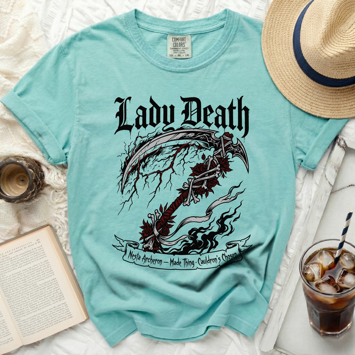 Aqua t-shirt with Lady Death scythe graphic and text.