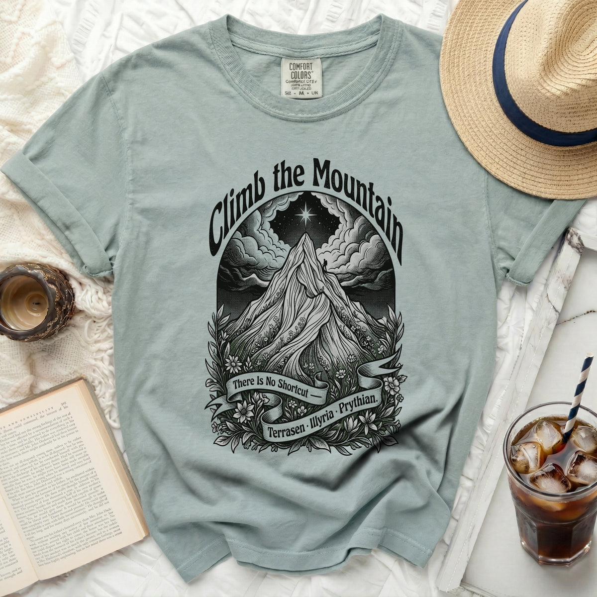 Light blue t-shirt with "Climb the Mountain" graphic and text.