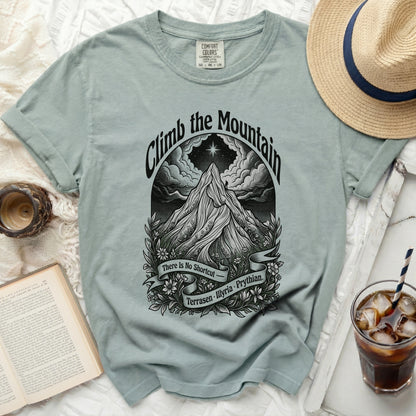 Light blue t-shirt with "Climb the Mountain" graphic and text.