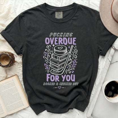 Black t-shirt with "Pucking Overdue Booked & Checked Out" text and hockey puck.