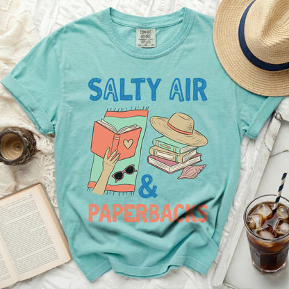 Teal t-shirt with "Salty Air & Paperbacks" book and hat graphic.