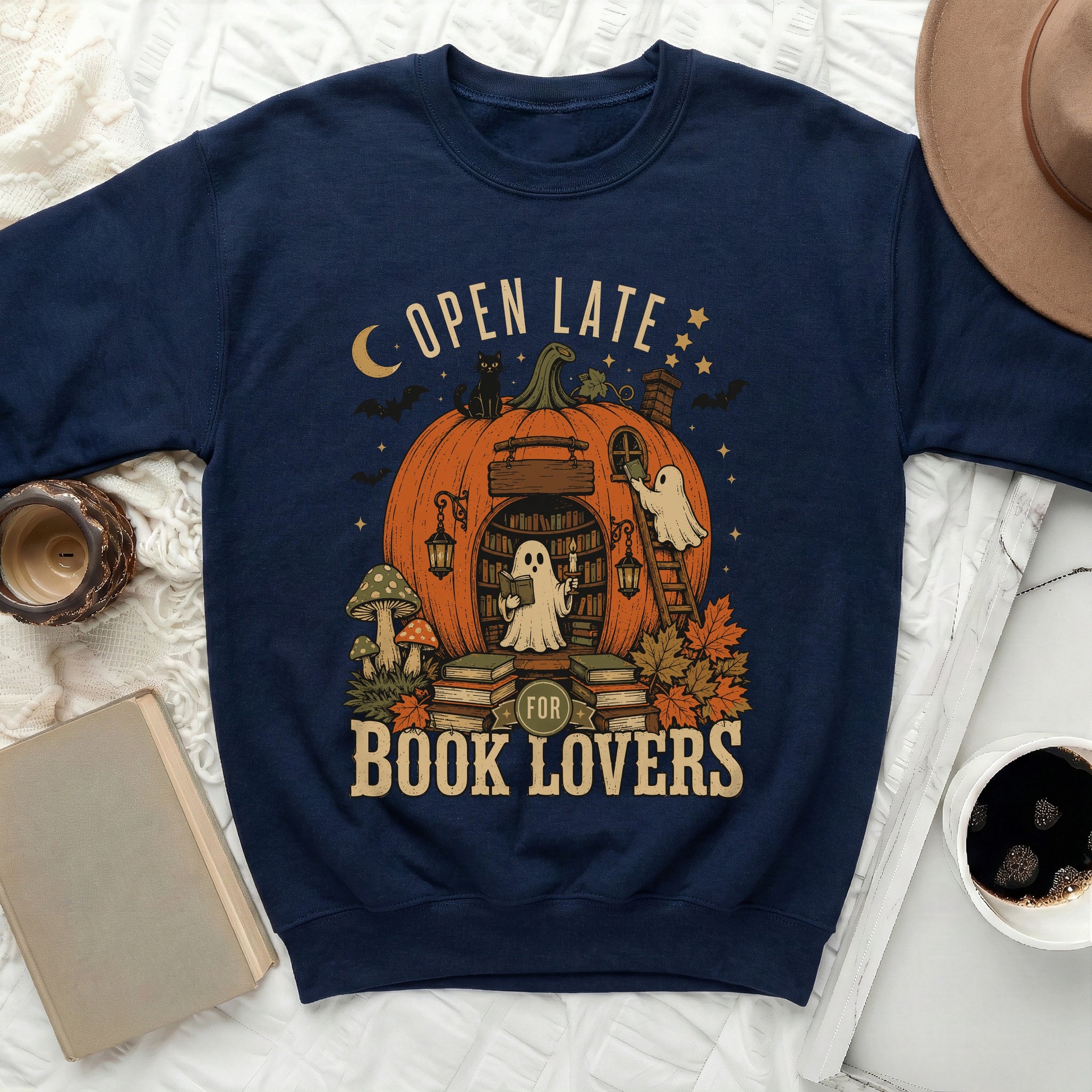 Navy sweatshirt with "Open Late For Book Lovers" and a Halloween-themed pumpkin library design.