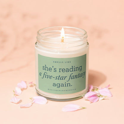 Lit candle with text "smells like she's reading a five-star fantasy again."