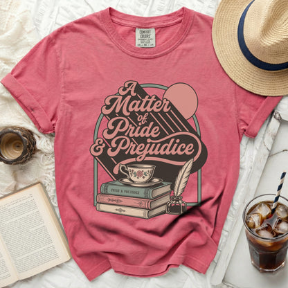 T-shirt with "A Matter of Pride & Prejudice" graphic, tea cup, and books.