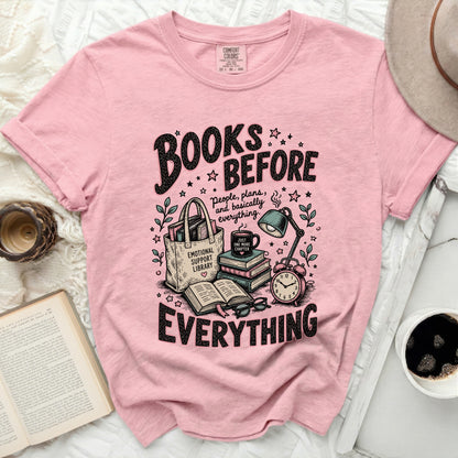 Pink t-shirt with "Books Before Everything" graphic.