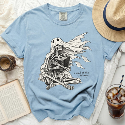 Skeleton ghost reading a book with the text "i died at the cliffhanger."