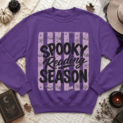 Purple sweatshirt with "Spooky Reading Season" text, books, spiders, and cobwebs.
