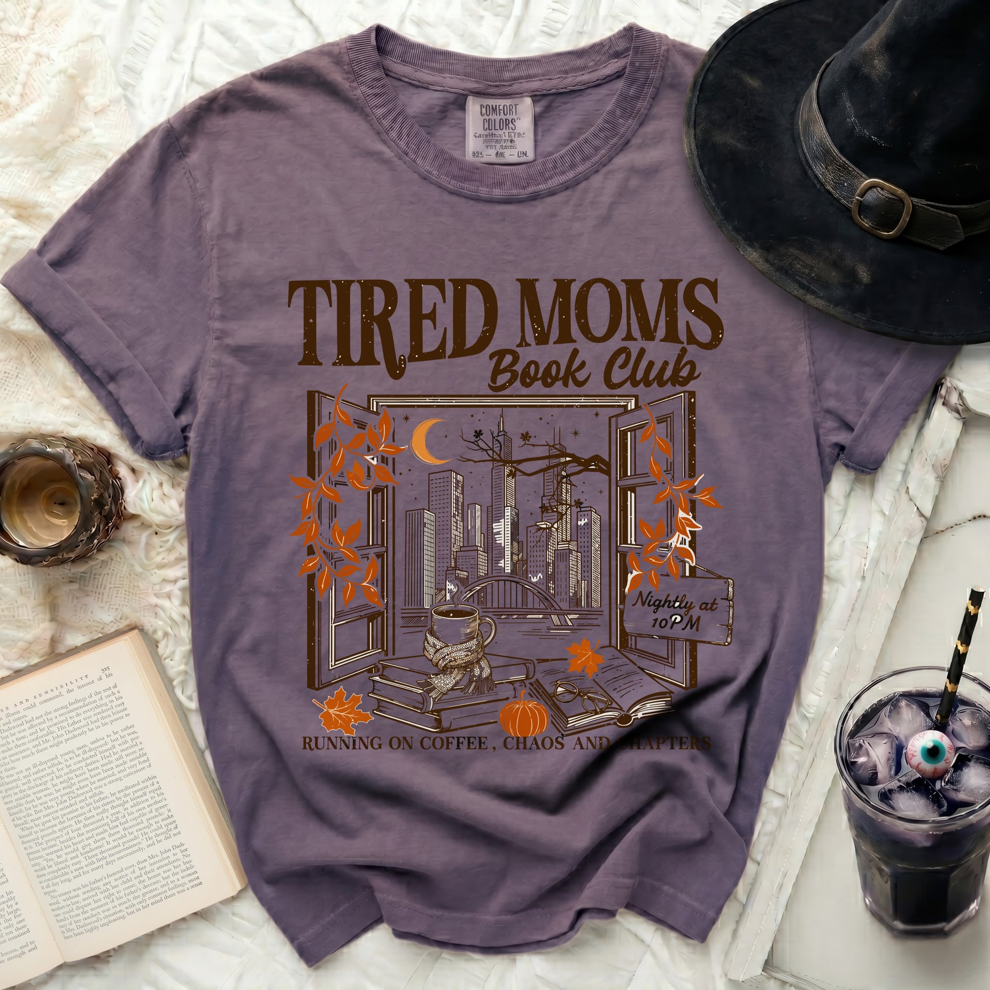 Tired Moms Book Club graphic tee with city view and coffee.
