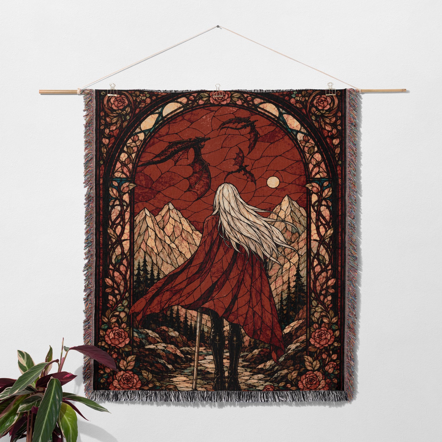 a tapestry hanging on a wall, depicting a woman with long hair standing in a mountainous landscape under a night sky.