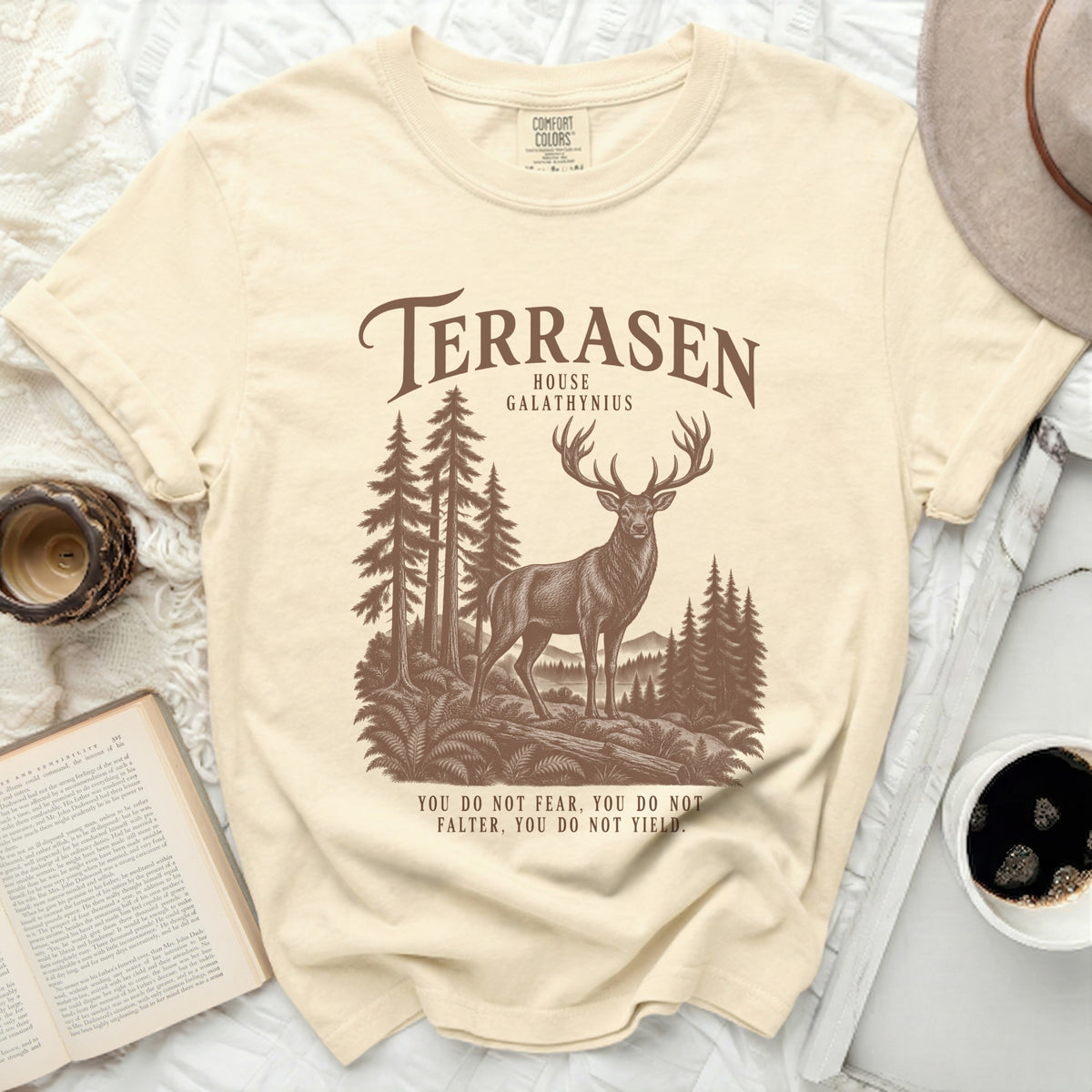 Cream t-shirt with "Terrasen House Galathynius" and a stag in a forest.