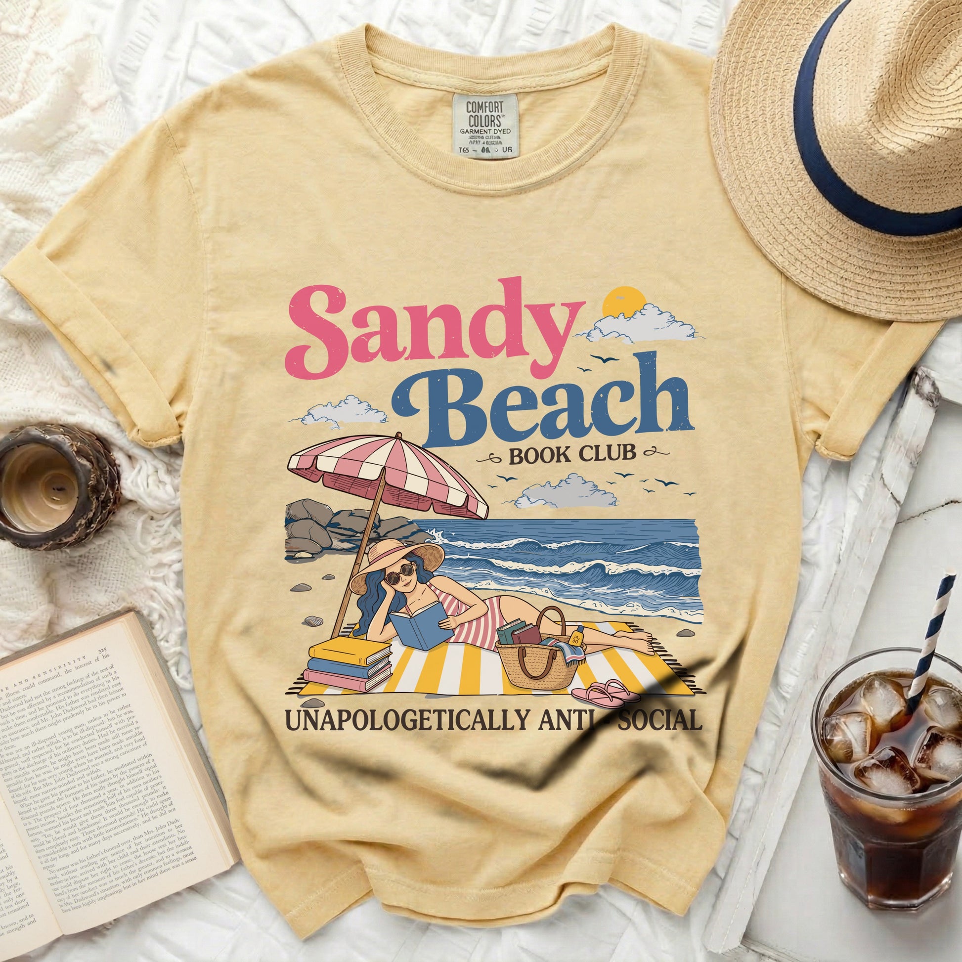 Sandy Beach Book Club graphic on yellow t-shirt with beach scene.