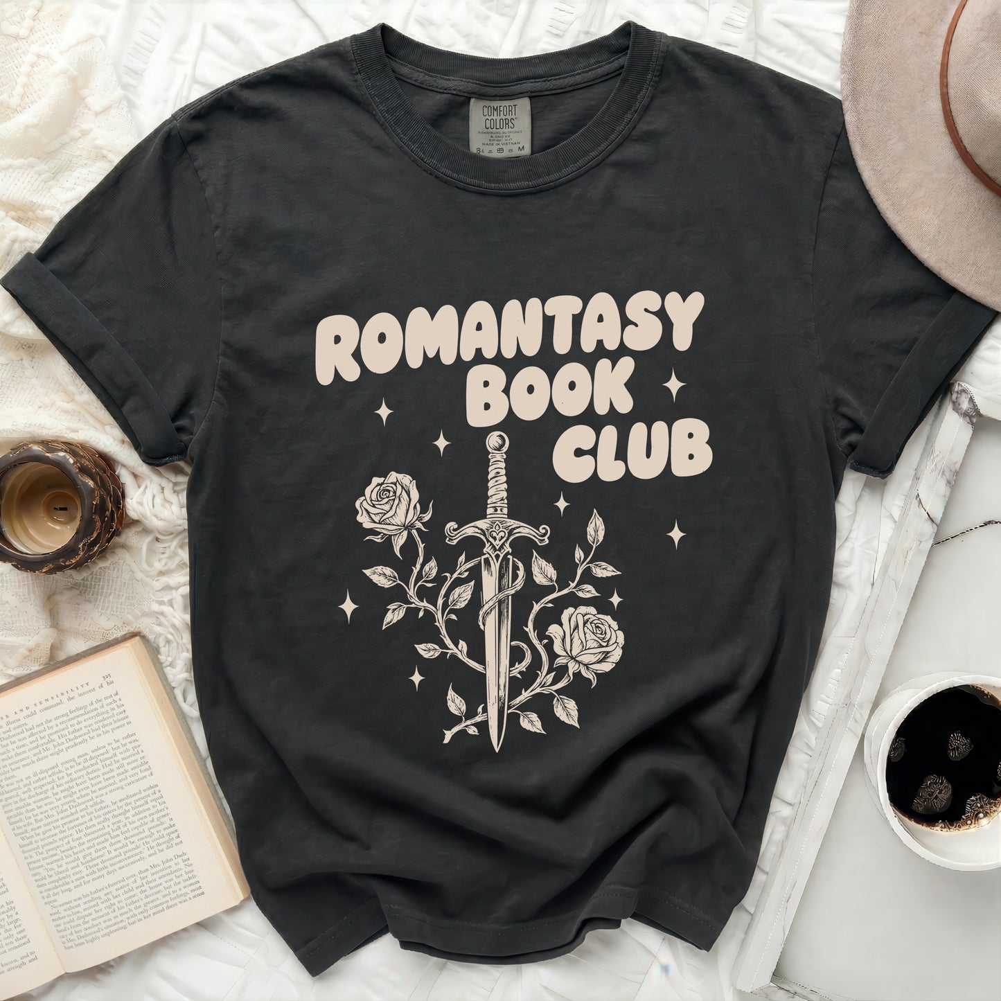 Black t-shirt with a cream graphic of a sword tangled in roses.