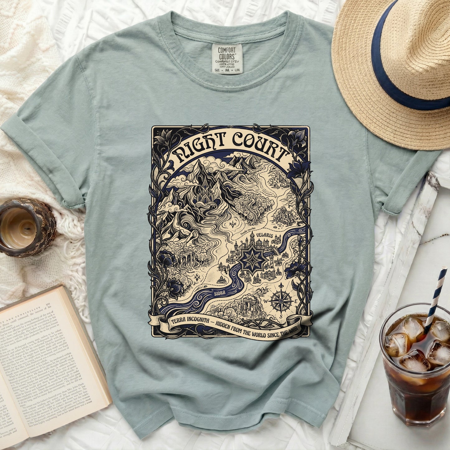 Light blue t-shirt with a map design for "Night Court" and "Terra Incognita" text.