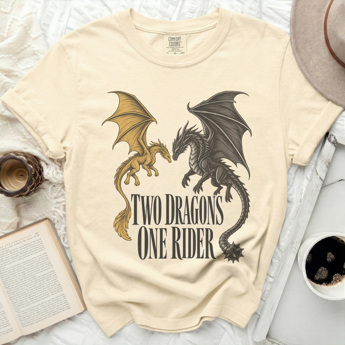 Cream t-shirt with graphic of two dragons and text "TWO DRAGONS ONE RIDER".