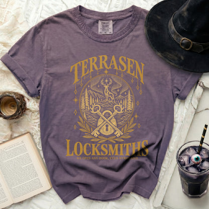 Purple t-shirt with gold "Terrasen Locksmiths" graphic featuring keys and a deer.