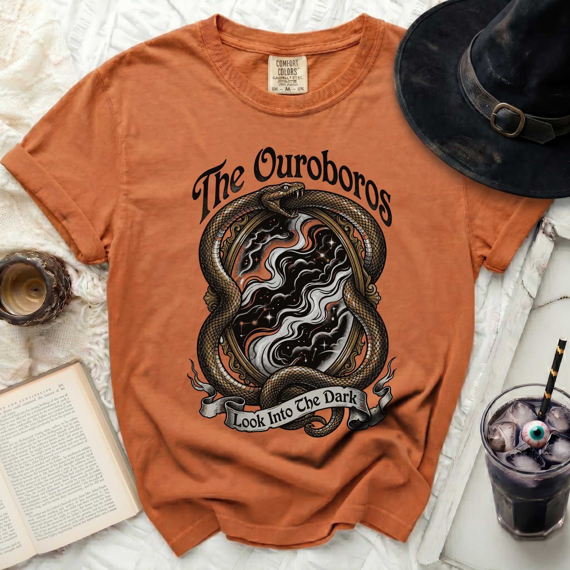 Orange t-shirt with ouroboros snake design and text "The Ouroboros Look Into The Dark".