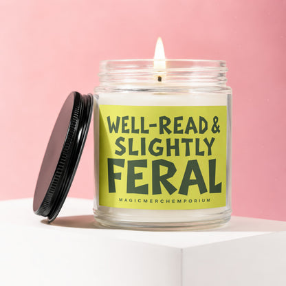 Lit glass jar candle with label reading "Well-Read & Slightly Feral".
