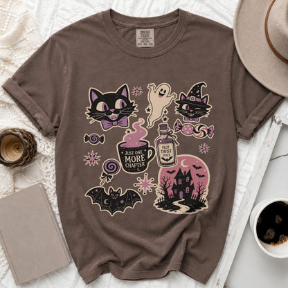 Brown t-shirt with Halloween-themed graphics including cats, ghost, bat, haunted house, and text.