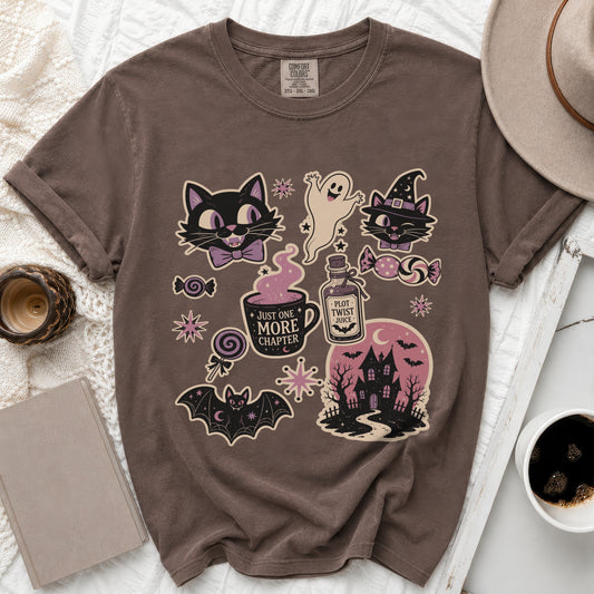 Brown t-shirt with Halloween-themed graphics including cats, ghost, bat, haunted house, and text.