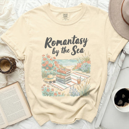 "Romantasy by the Sea" text on a t-shirt with books and beach items.