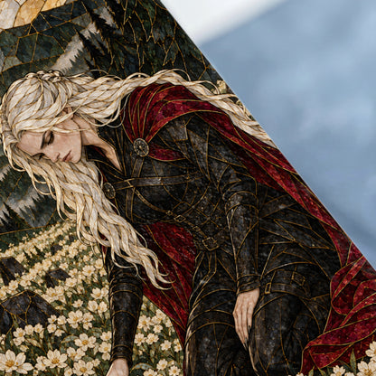 Fallen warrior with blonde braid in black armor and red cape among white flowers.