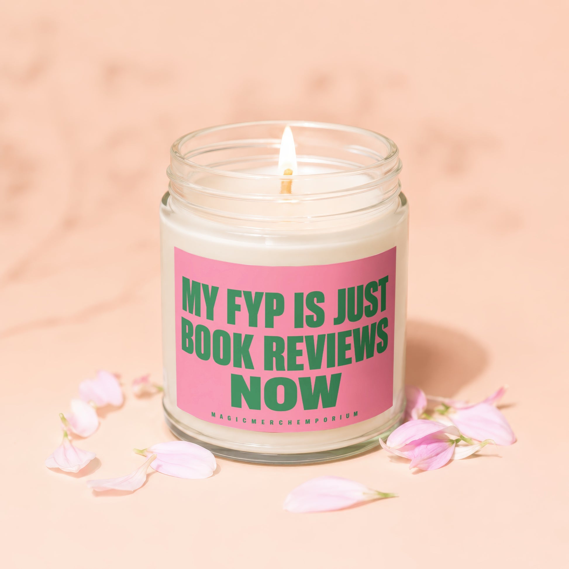 Lit candle in glass jar surrounded by pink petals with text "MY FYP IS JUST BOOK REVIEWS NOW".
