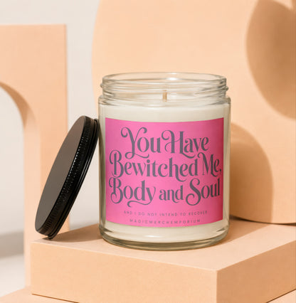 Candle with pink label that says "You Have Bewitched Me Body and Soul."