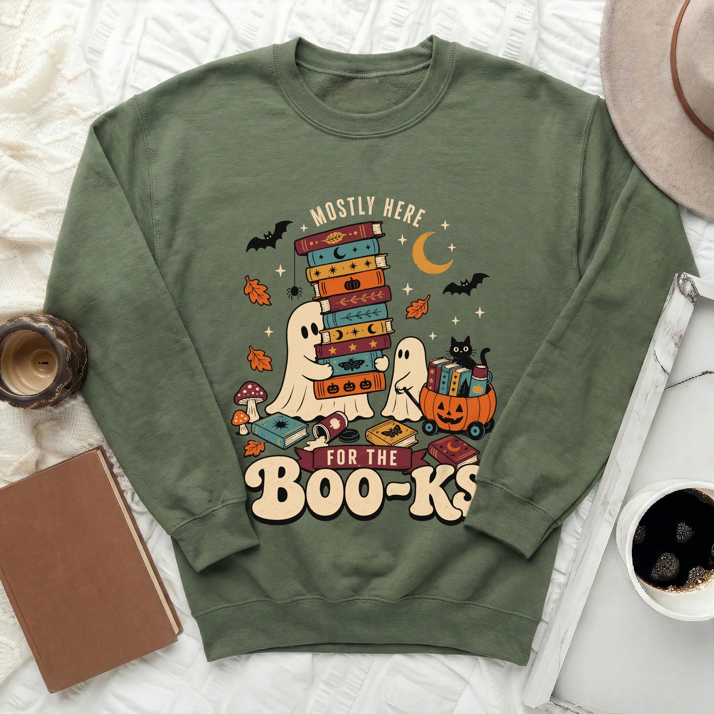 Green sweatshirt with ghosts, books, bats, and the text "Mostly Here for the Boo-Ks."