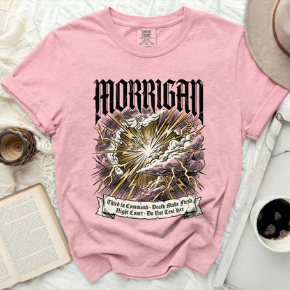 Pink t-shirt with "MORRIGAN" and lightning graphics with text.