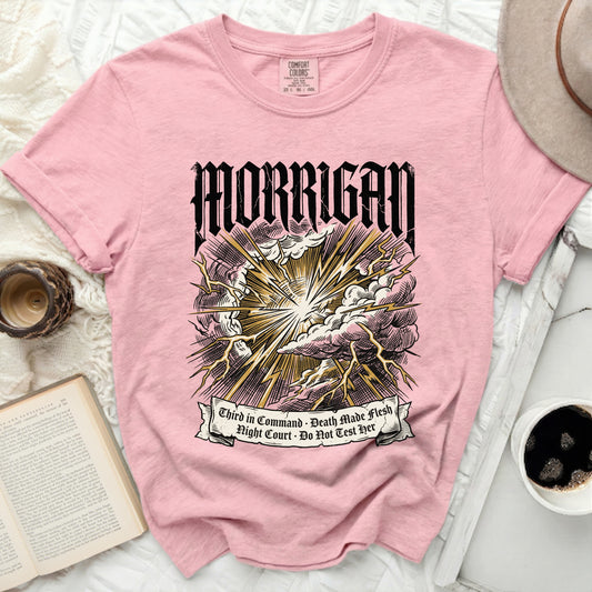 Pink t-shirt with "MORRIGAN" and lightning graphics with text.
