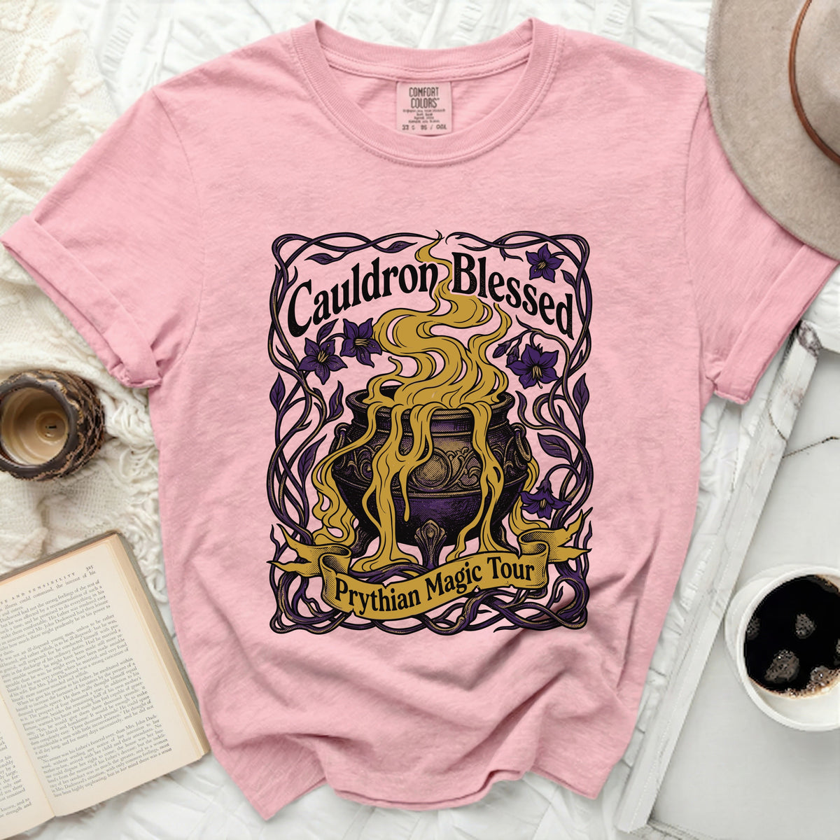 Pink t-shirt with "Cauldron Blessed" and "Prythian Magic Tour" graphics.